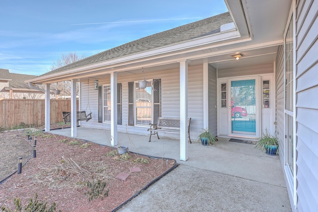 view of exterior entry featuring covered porch