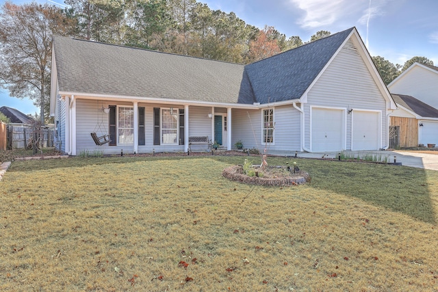 view of front of home with a porch, a garage, and a front yard