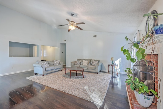 living room with ceiling fan, high vaulted ceiling, dark hardwood / wood-style floors, and a textured ceiling