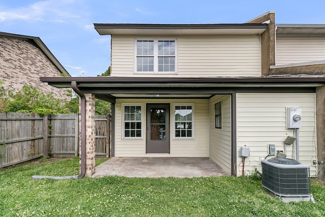 back of house featuring fence, a lawn, a patio, and cooling unit