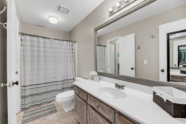 bathroom featuring tile patterned floors, toilet, and vanity