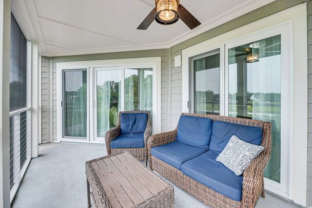 sunroom / solarium featuring ceiling fan