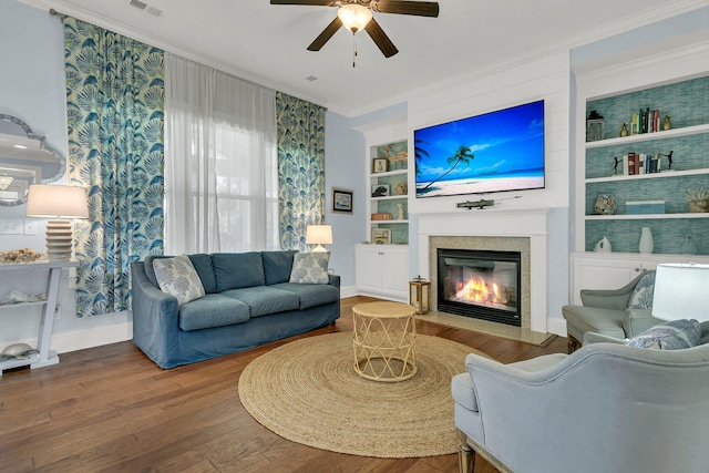 1325 Whisker Pole Ln, Mount Pleasant, SC 29466 - living area with ceiling fan, built in features, wood finished floors, a fireplace with flush hearth, and crown molding