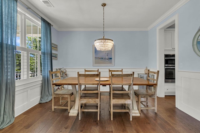 1325 Whisker Pole Ln, Mount Pleasant, SC 29466 - dining area featuring a decorative wall, ornamental molding, a chandelier, wainscoting, and wood finished floors