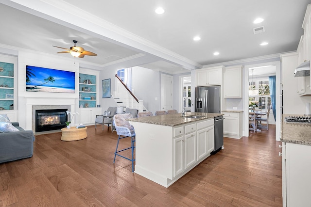 1325 Whisker Pole Ln, Mount Pleasant, SC 29466 - kitchen with a sink, open floor plan, crown molding, stainless steel appliances, and a fireplace with flush hearth