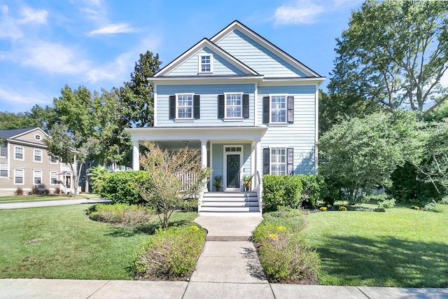 view of front of home with a front yard and a porch