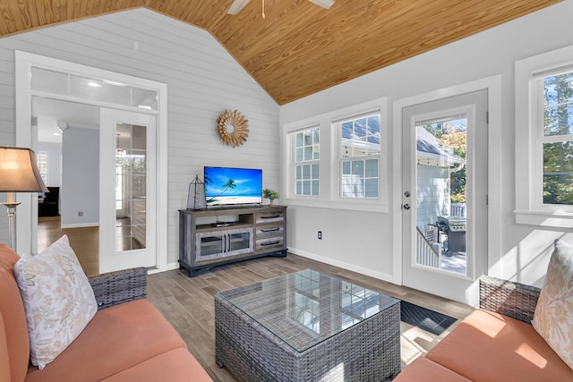 living room with high vaulted ceiling, wood walls, hardwood / wood-style flooring, wooden ceiling, and ceiling fan