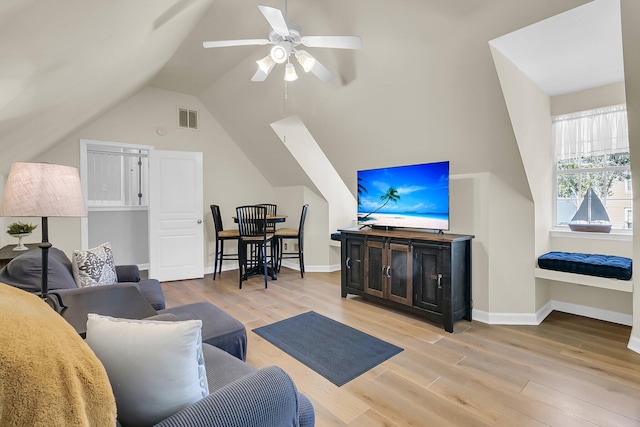 living room with light wood-type flooring, lofted ceiling, and ceiling fan