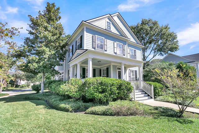 neoclassical home with a front lawn and a porch