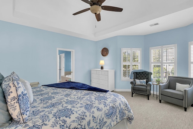 carpeted bedroom featuring ceiling fan and ensuite bath