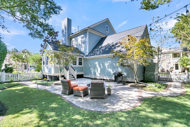 back of house featuring outdoor lounge area, a patio, and a yard