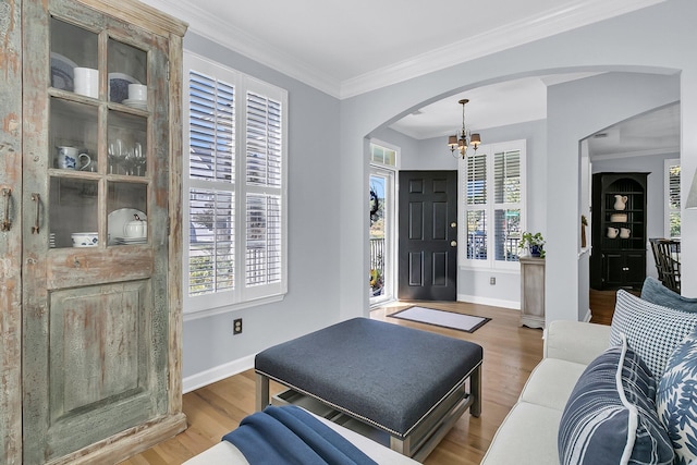 living room featuring hardwood / wood-style flooring, plenty of natural light, and ornamental molding