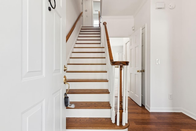 stairway featuring hardwood / wood-style flooring and crown molding