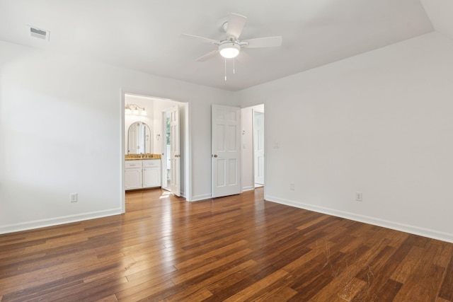 unfurnished bedroom featuring ceiling fan, dark hardwood / wood-style floors, and ensuite bath