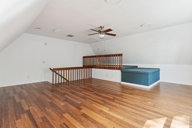 additional living space with ceiling fan, hardwood / wood-style floors, and vaulted ceiling