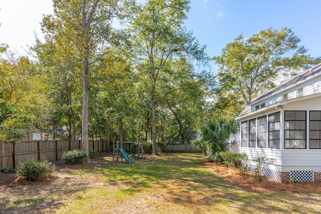 view of yard with a playground and a sunroom