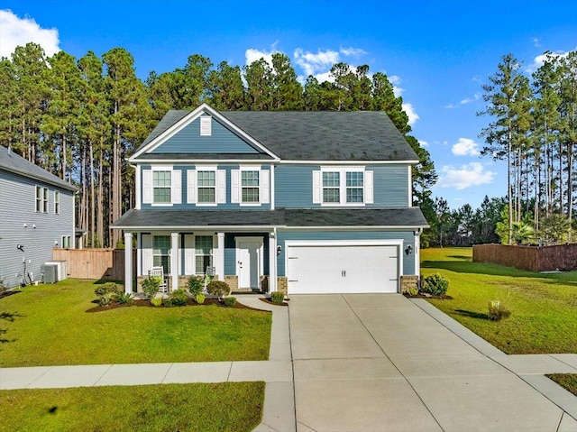 view of front of home featuring central AC, a front yard, and a garage