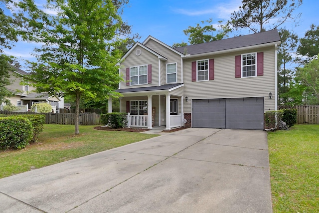 view of front of house featuring covered porch, a garage, and a front yard