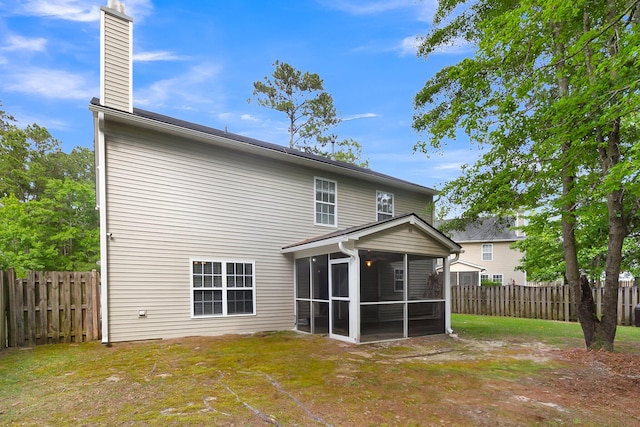 back of house featuring a sunroom