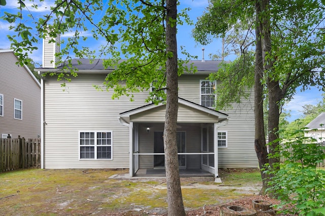 rear view of property with a patio area and a sunroom