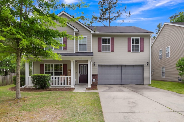 view of front of house featuring covered porch, a garage, and a front yard