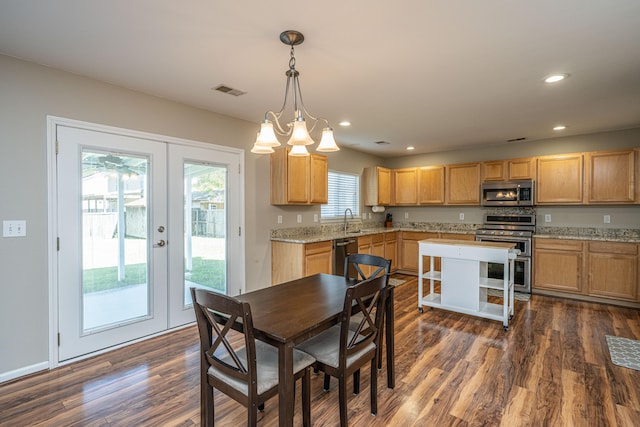 dining space with french doors, a healthy amount of sunlight, and dark hardwood / wood-style floors