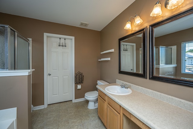 bathroom featuring vanity, a shower with shower door, toilet, and tile patterned floors