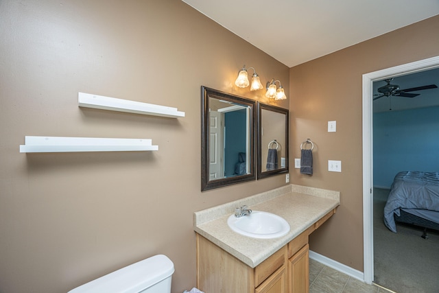 bathroom featuring vanity, tile patterned floors, toilet, and ceiling fan