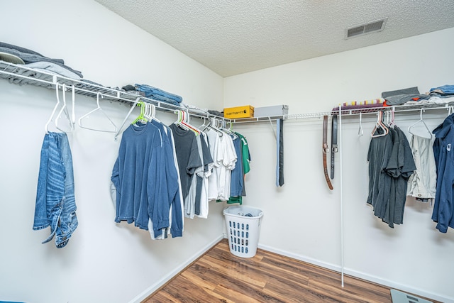 walk in closet featuring dark hardwood / wood-style floors