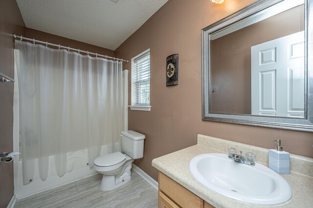 full bathroom with vanity, shower / tub combo, a textured ceiling, and toilet