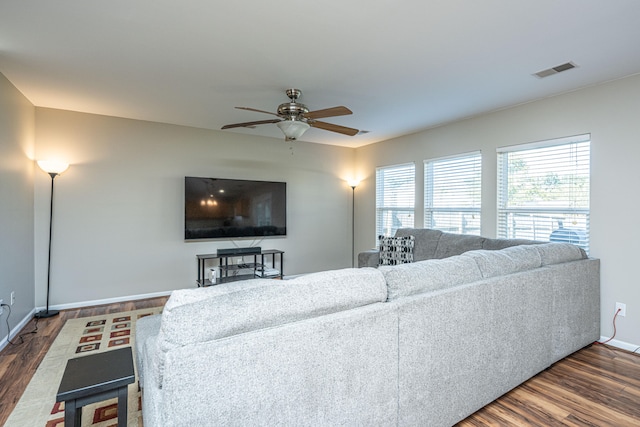 living room with ceiling fan and dark hardwood / wood-style flooring