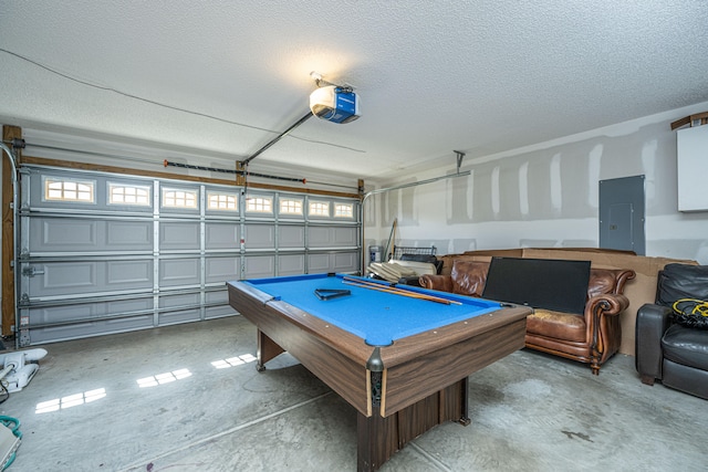 recreation room with plenty of natural light, electric panel, pool table, and concrete flooring