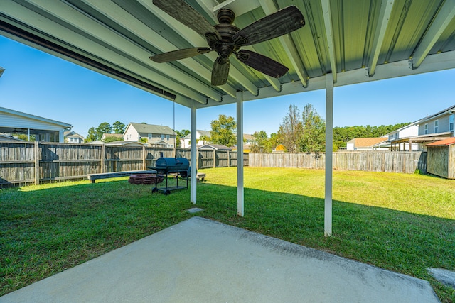 view of yard featuring a patio area and ceiling fan