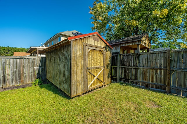 view of outbuilding featuring a yard