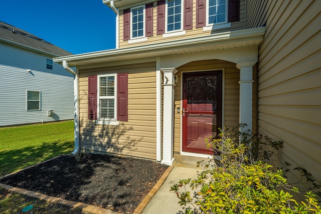 doorway to property with a yard