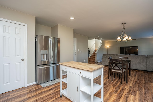 kitchen with wooden counters, a notable chandelier, stainless steel refrigerator with ice dispenser, and dark hardwood / wood-style floors