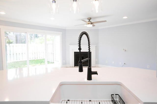 interior details featuring recessed lighting, light countertops, ceiling fan, and ornamental molding