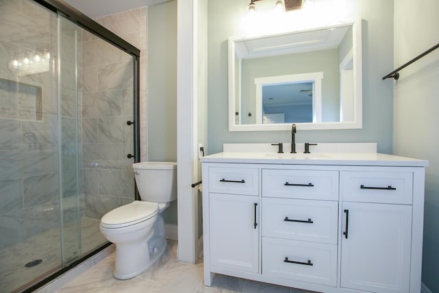 bathroom with toilet, marble finish floor, a stall shower, and vanity