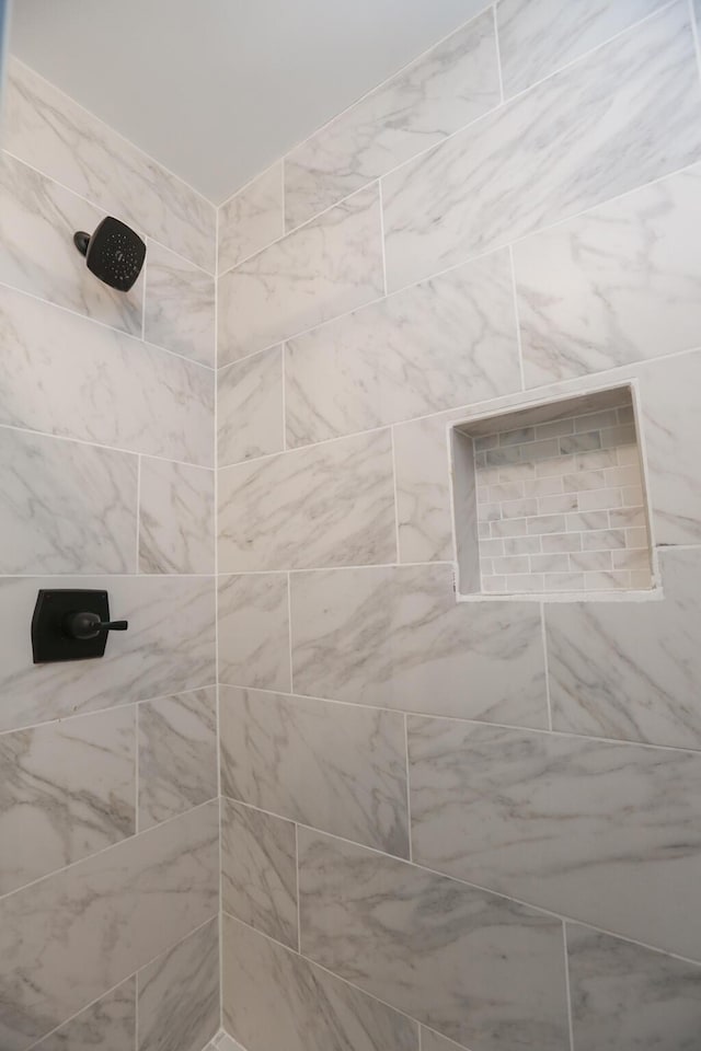 full bathroom with a tile shower