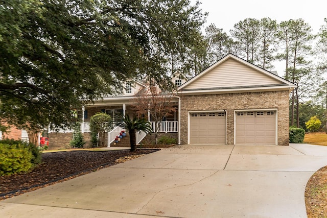 view of front of property with a porch and a garage