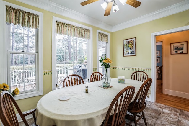 tiled dining area featuring ceiling fan and ornamental molding