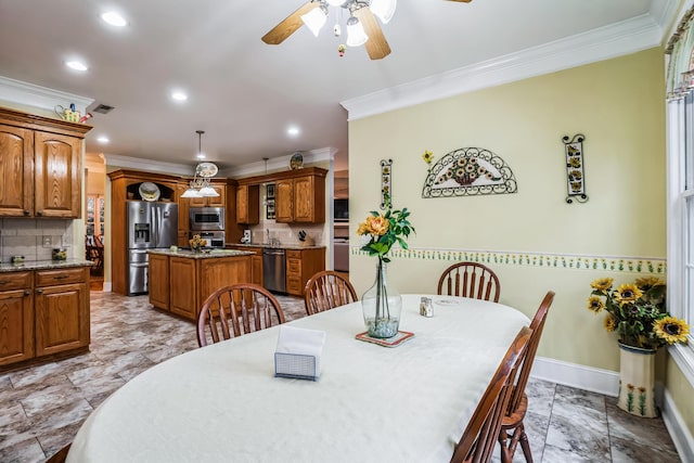 dining room with ceiling fan and crown molding