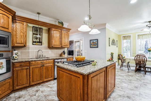 kitchen with appliances with stainless steel finishes, backsplash, ceiling fan, sink, and pendant lighting