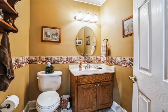 bathroom with crown molding, vanity, and toilet