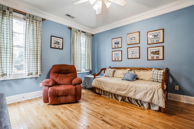 bedroom with light hardwood / wood-style flooring, ceiling fan, and crown molding