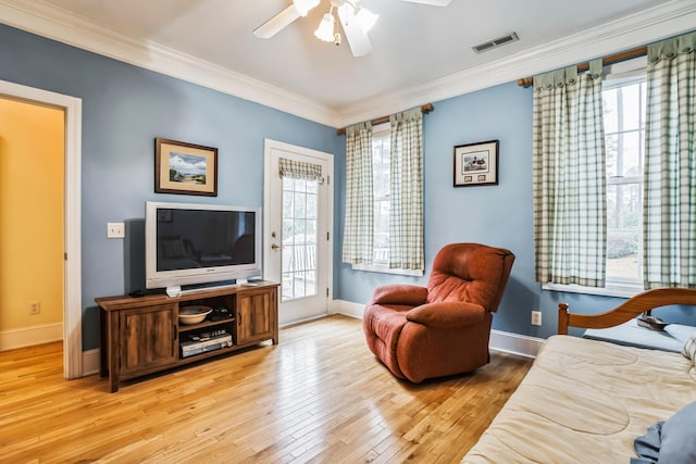 interior space with hardwood / wood-style flooring, ceiling fan, and ornamental molding