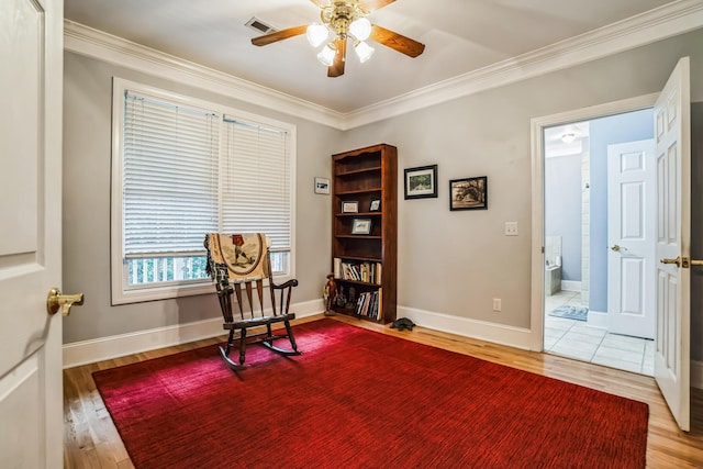 living area with ceiling fan, hardwood / wood-style flooring, and ornamental molding