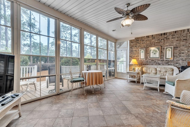 sunroom featuring ceiling fan