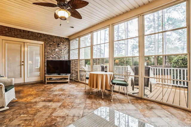 sunroom / solarium featuring ceiling fan