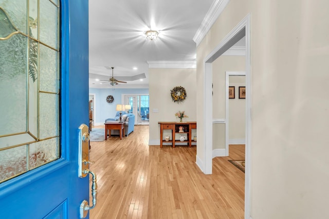 entrance foyer featuring light hardwood / wood-style flooring, ceiling fan, and ornamental molding